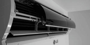 Close-up shot of modern air conditioner louver at slight angle not moving properly, with faint LG and Samsung logos in background, clean residential interior setting with subtle concerned highlight on broken part